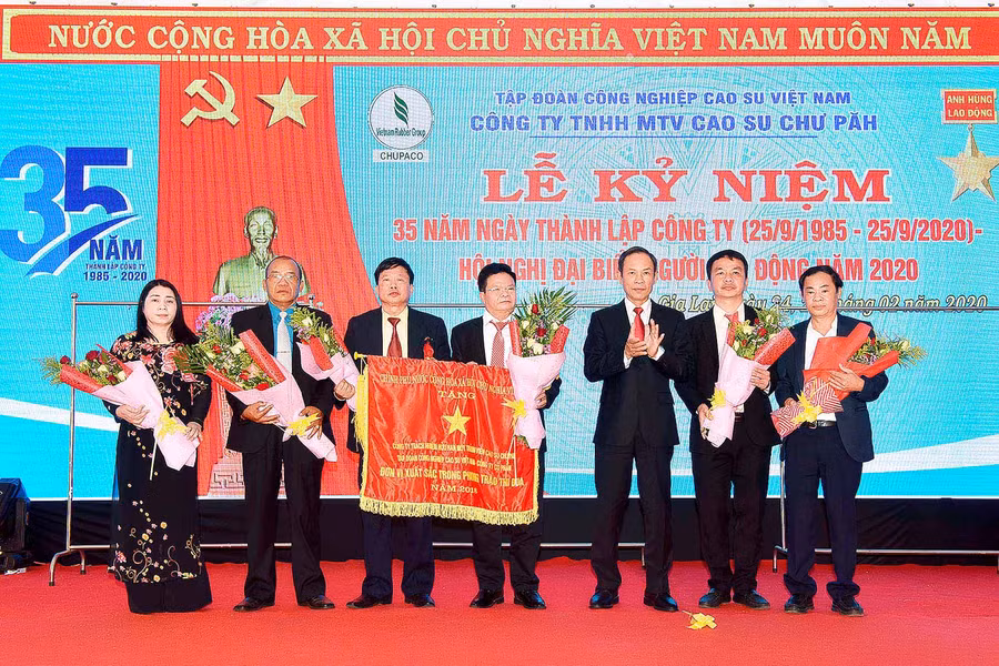 Thừa ủy quyền của Thủ tướng Chính phủ, ông Trần Ngọc Thuận-Chủ tịch HĐQT Tập đoàn Công nghiệp Cao su Việt Nam trao cờ thi đua xuất sắc của Chính phủ cho Công ty TNHH một thành viên Cao su Chư Pah. Ảnh: Đức Thụy