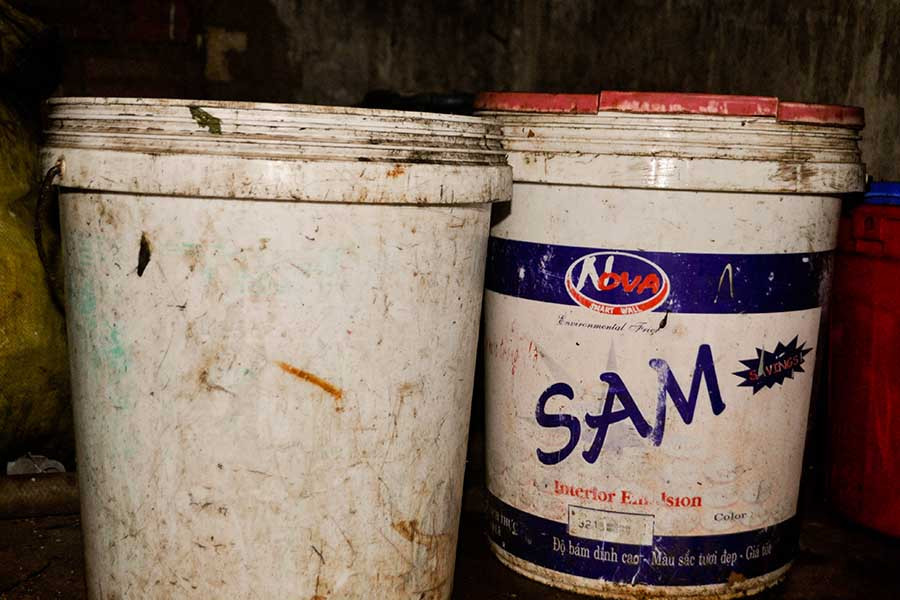 Vỏ thùng sơn dùng để muối dưa cải đã cũ, cáu bẩn và bám những mảng màu vàng đục. Ảnh: Trần Dung