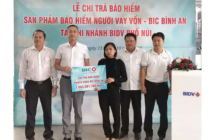  Đại diện Ban lãnh đạo BIDV Chi nhánh Phố Núi và Bảo hiểm BIDV thực hiện chi trả bảo hiểm cho bà Đinh Thị Bích Phương - thân nhân khách hàng. Ảnh: Sơn Ca Sơn Ca