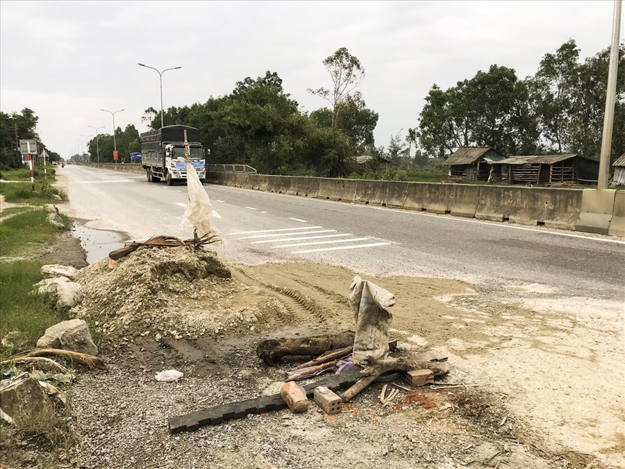 Đống đá cấp phối được lực lượng chức năng đổ để sửa đường nhưng không dọn sạch khiến người dân bất an.