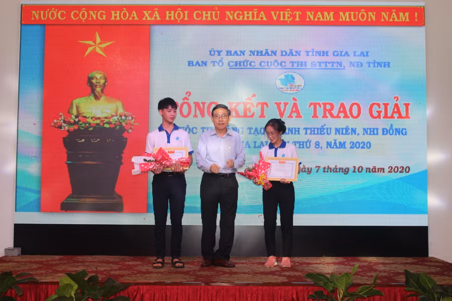 Ông Lê Duy Định-Phó Giám đốc Sở Giáo dục và Đạo tạo trao giải nhì cho đại diện 2 nhóm tác giả đạt giải. Ảnh: Thủy Bình