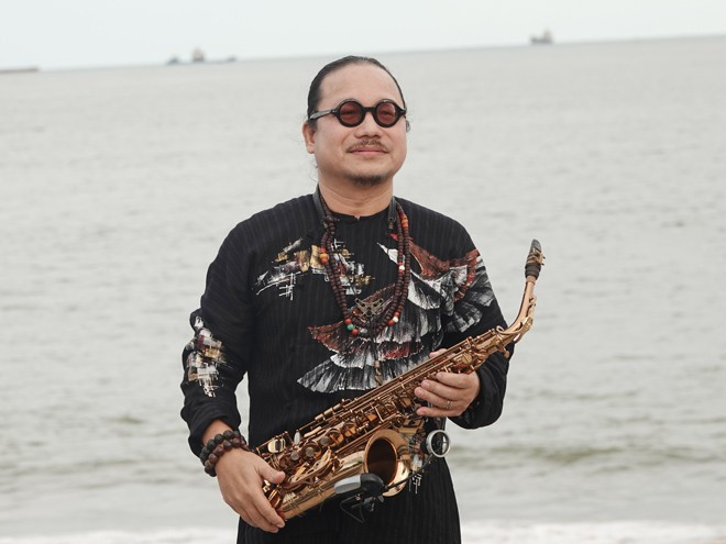 Nhạc sĩ Trần Mạnh Tuấn bắt đầu thể hiện bài hát Biển nhớ khi đi lên từ phía biển... ẢNH: HOÀNG TRỌNG