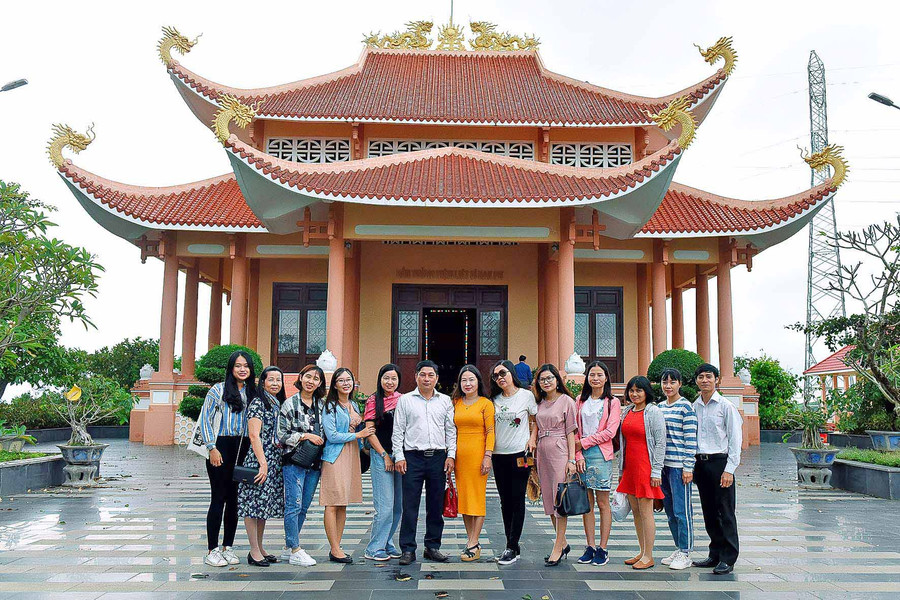 Du khách chụp ảnh lưu niệm trước Đền tưởng niệm liệt sĩ Đak Pơ. Ảnh: Đức Thụy