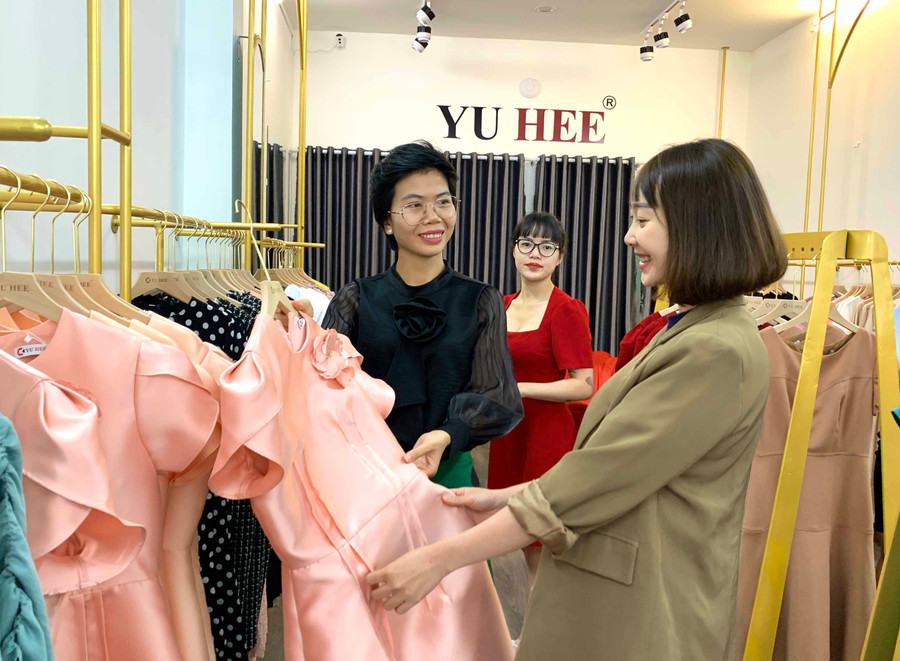 Chị Giang Thị Hoài Phương (bìa trái) tiếp khách hàng tại shop Yu Hee. Ảnh: Hà Duy