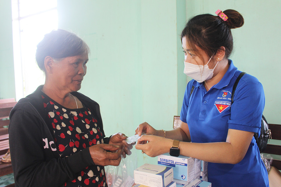 Thành viên Câu lạc bộ Thầy thuốc trẻ huyện Chư Păh hướng dẫn người dân làng Mun (thị trấn Ia Ly) sử dụng thuốc điều trị bệnh. Ảnh: Phan Lài