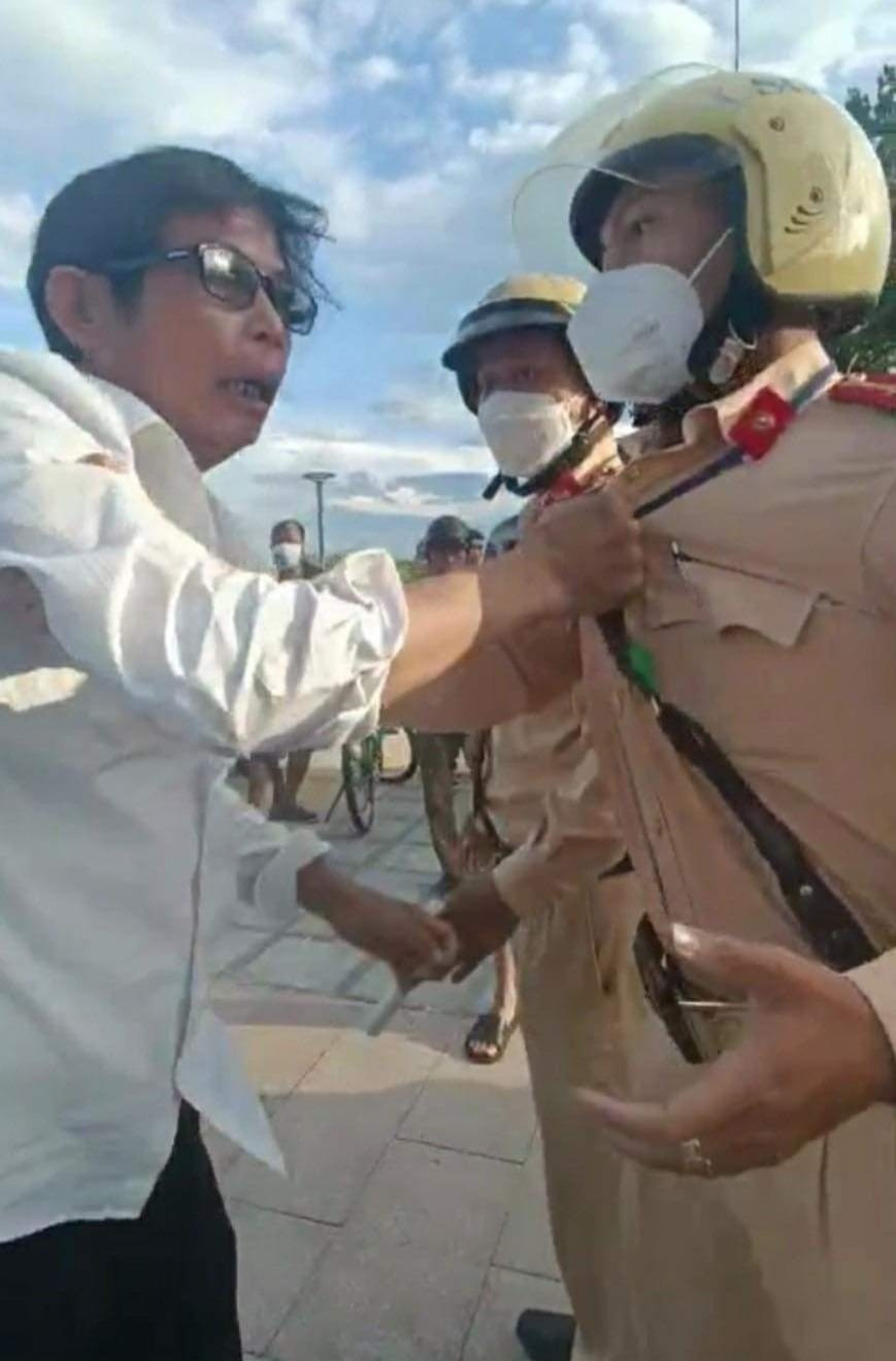 Tấn nắm cổ áo chiến sĩ cảnh sát để bênh vực bạn nhậu. Ảnh: CẮT TỪ CLIP Tấn nắm cổ áo chiến sĩ cảnh sát để bênh vực bạn nhậu. Ảnh: CẮT TỪ CLIP