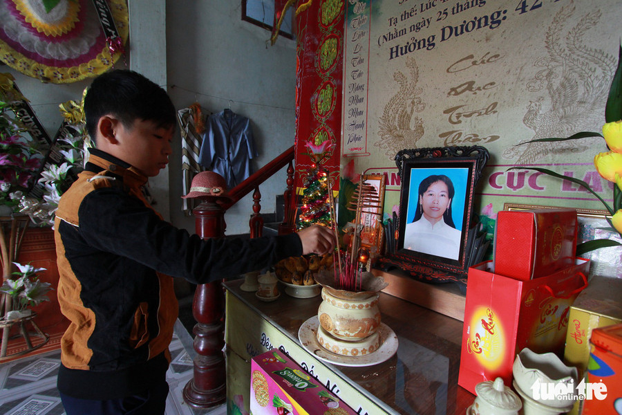 Con trai chị Lương Thị Thu Dung thắp nhang bên di ảnh mẹ. Con trai chị Lương Thị Thu Dung thắp nhang bên di ảnh mẹ.