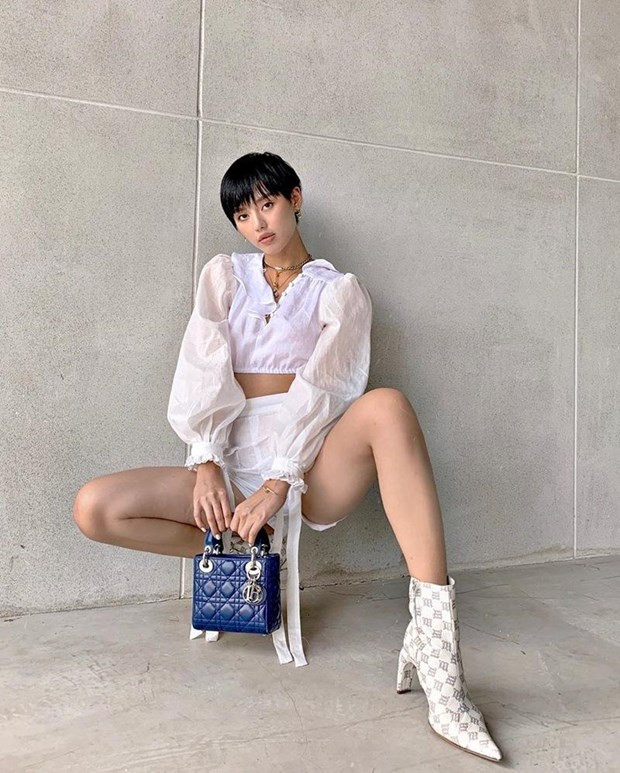  Crop top tay phồng và quần shorts cạp cao phối theo phong cách matchy-matchy, phối cùng boots cao gót giúp Khánh Linh khai thác triệt để lợi thế chân dài. Chiếc túi Dior nhỏ xinh màu xanh hoàng gia vừa vặn trở thành điểm nhấn, chấm phá cho bộ đồ tuyền trắng.