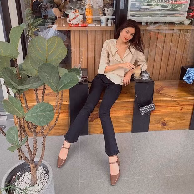 Kim Dung không phô khoảng hở vẫn khoe trọn đôi chân dài miên man nhờ diện quần ống vẩy, ôm trên xòe dưới. Cô nàng phối quần cùng giày có quai, mix với áo blouse màu sắc đối lập, in đậm style tối giản.