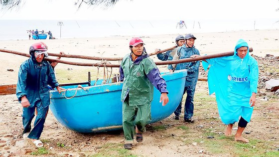 Ngư dân xã Quảng Phú, huyện Quảng Trạch (Quảng Bình) đưa thuyền thúng vào bờ chạy bão. Ảnh: MINH PHONG