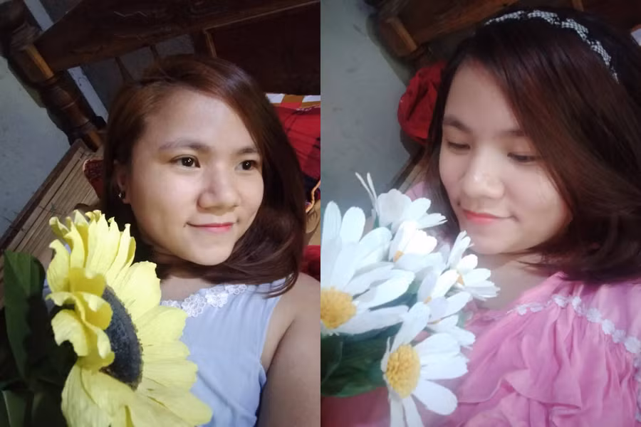 Lê Thị Linh tự tin chụp với những bông hoa giấy mình tự làm.