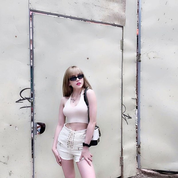 Cặp đôi crop top cổ yếm và quần shorts cạp cao màu sáng không những tô đậm nước da trắng sứ mà còn tôn lên 3 vòng gợi cảm của thiều Bảo Trâm.