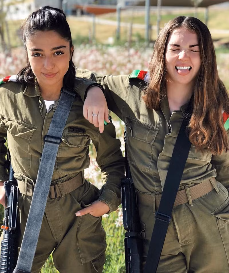  Nữ quân nhân bên trái đang nghiêm túc tạo dáng chụp ảnh thì cô nàng đồng đội bên phải bất ngờ “phá bĩnh” bằng cách nhắm tịt mắt lại.