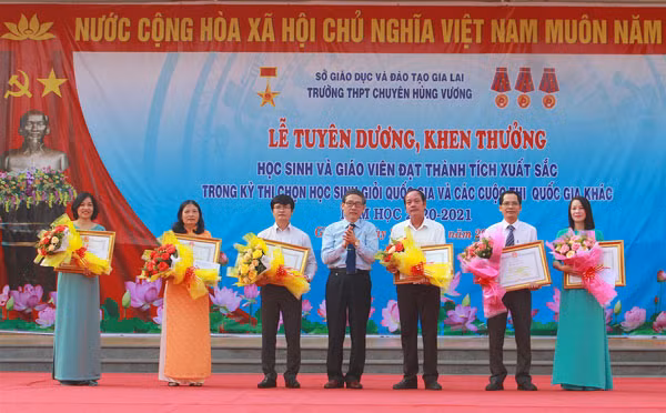 Giám đốc Sở GD-ĐT Lê Duy Định trao tặng bằng khen của Chủ tịch UBND tỉnh cho 6 giáo viên có thành tích xuất sắc trong việc bồi dưỡng học sinh tham dự Kỳ thi chọn học sinh giỏi quốc gia THPT năm học 2020-2021. Ảnh: Hồng Thi.
