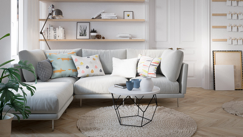 Một chiếc ghế sofa màu xám, mềm mại đặt cạnh một bàn cà phê.