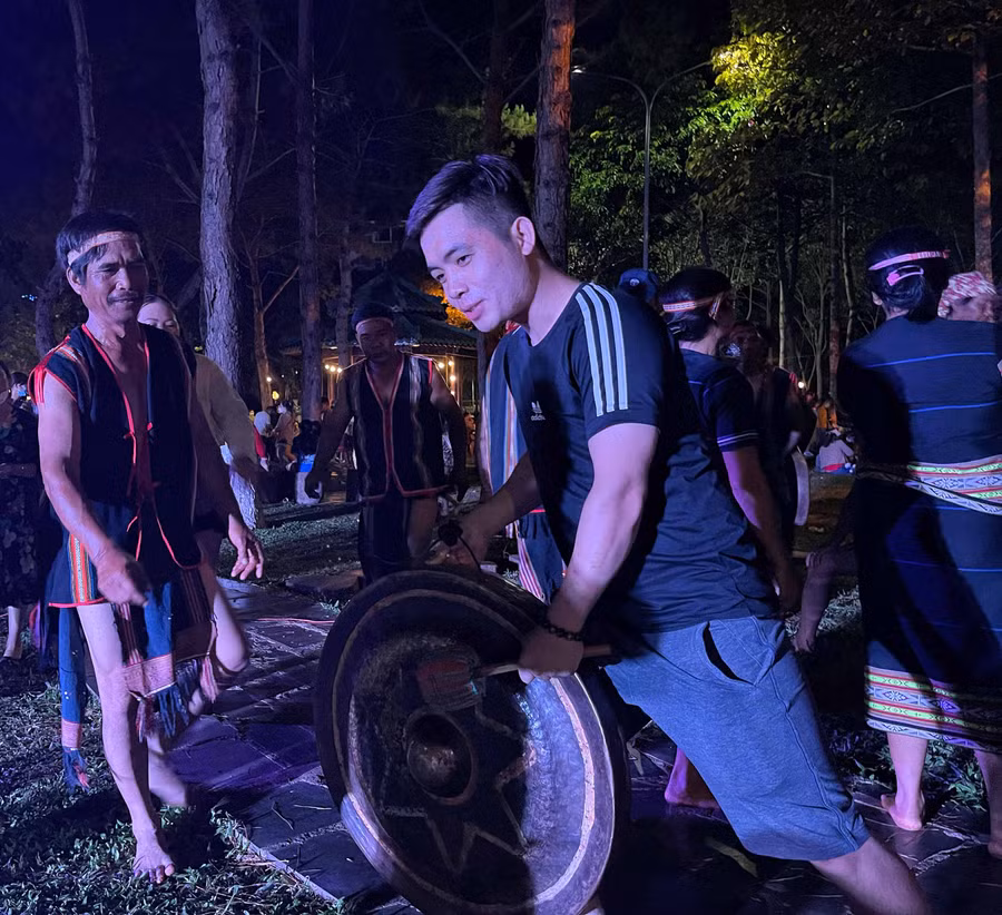 Nghệ nhân huyện Đak Đoa hướng dẫn du khách tư thế đánh cồng chiêng. Ảnh: Minh Châu