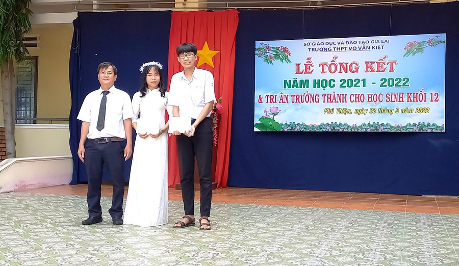 Thầy Sơn-đại diện Quỹ trao học bổng cho 2 em học sinh trường THPT Võ Văn Kiệt. Ảnh: Anh Huy