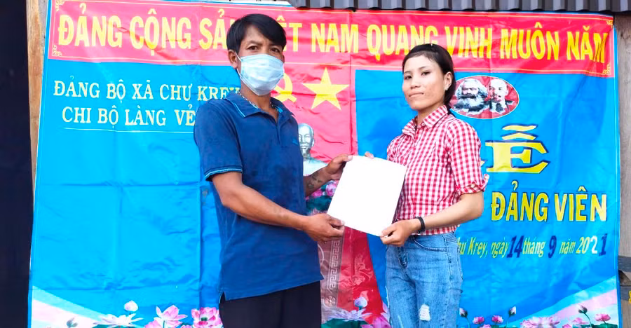 Đại diện Chi bộ làng Vẻh (xã Chư Krêy) trao quyết định kết nạp đảng viên cho chị Đinh Thị Bdên (người dân tộc Bahnar). Ảnh: Ngọc Minh