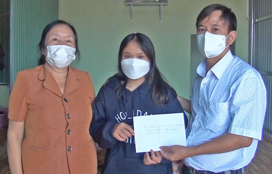 Thầy Sơn trao số tiền của bác sĩ Đỗ Thị Hồng Loan hỗ trợ em Kpă H’Thảo. Ảnh: Anh Huy