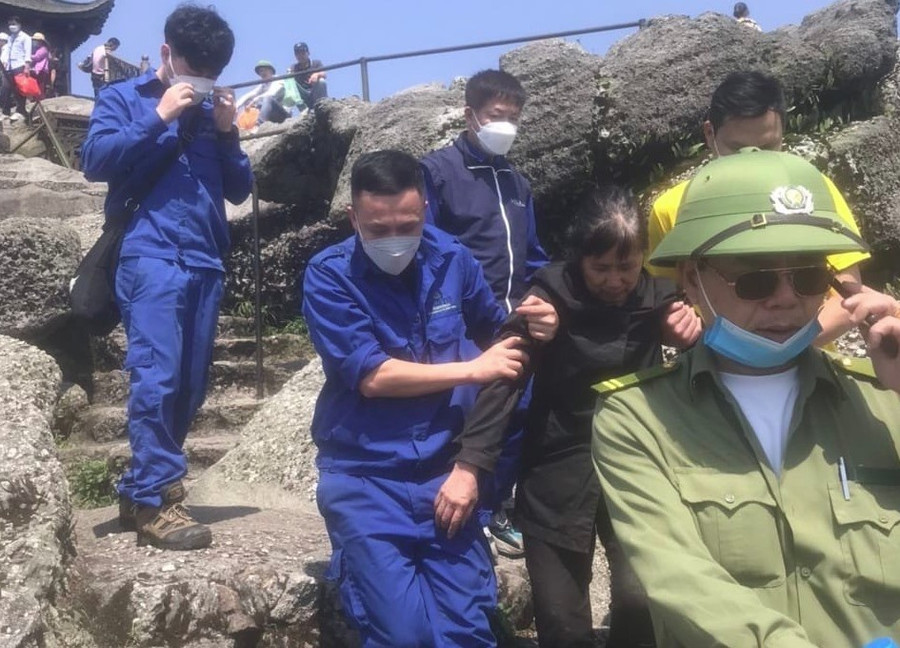 Bà Liên được đưa lên đỉnh núi sau 7 ngày mắc kẹt dưới vực sâu. Ảnh: Lê Dũng