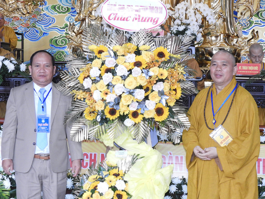 Phó Bí thư Tỉnh ủy Rah Lan Chung (bìa trái) tặng lẵng hoa chúc mừng Đại hội. Ảnh: Thanh Nhật