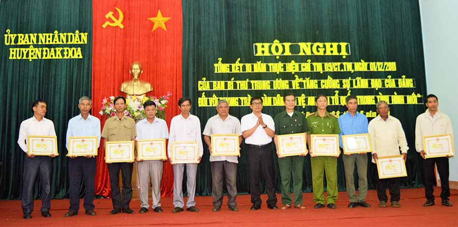  Chủ tịch UBND huyện Đak Đoa Phạm Minh Trung tặng giấy khen cho các tập thể, cá nhân có thành tích xuất sắc trong xây dựng Tổ tự quản về an ninh trật tự. Ảnh: Đ.Y