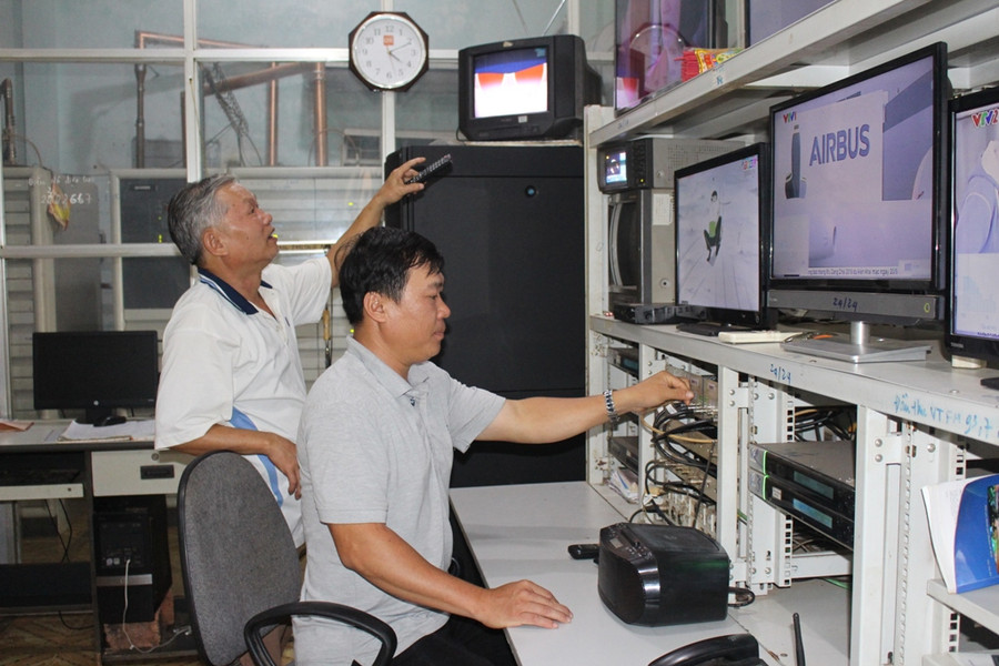  Từ trái sang: Ông Nguyễn Hồng Tòng và anh Nguyễn Văn Thành đang kiểm tra tín hiệu đường truyền. Ảnh: T.B