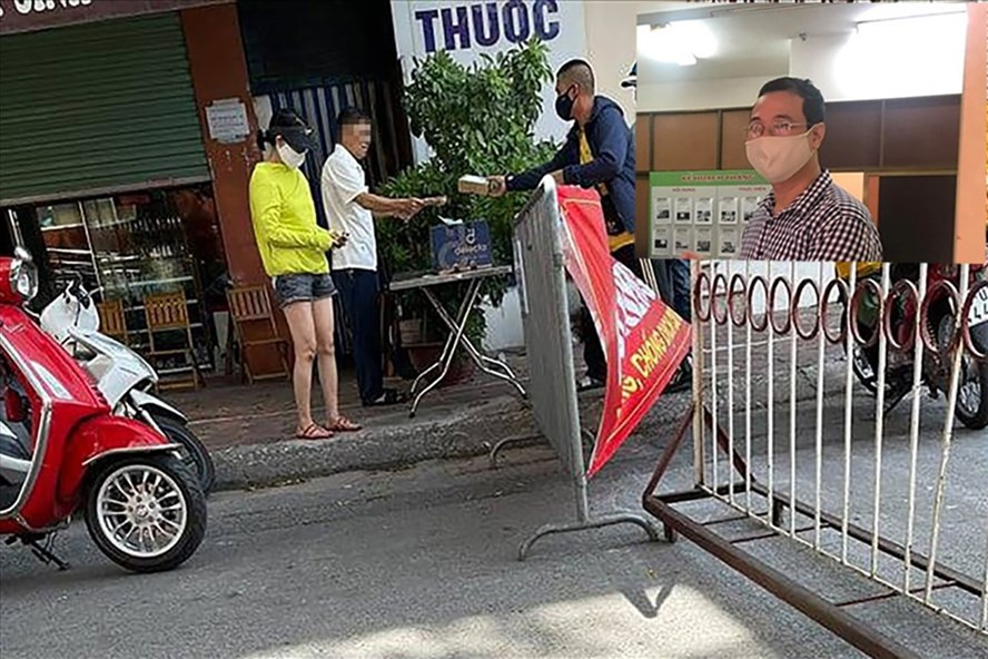 Chủ tịch UBND phường Tân Mai Nguyễn Thanh Tùng (ảnh nhỏ) ký quyết định xử phạt Bí thư Đảng uỷ phường Tân Mai (áo trắng) 2 triệu đồng vì vi phạm quy định phòng chống dịch COVID-19. Ảnh Thành Trung- PV