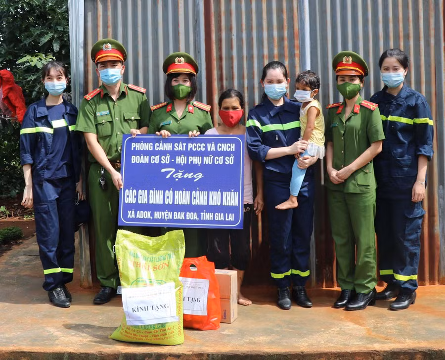 Cán bộ, chiến sĩ Phòng Cảnh sát PCCC-CNCH tặng quà cho người dân xã A Dơk (huyện Đak Đoa). Ảnh: Lê Anh