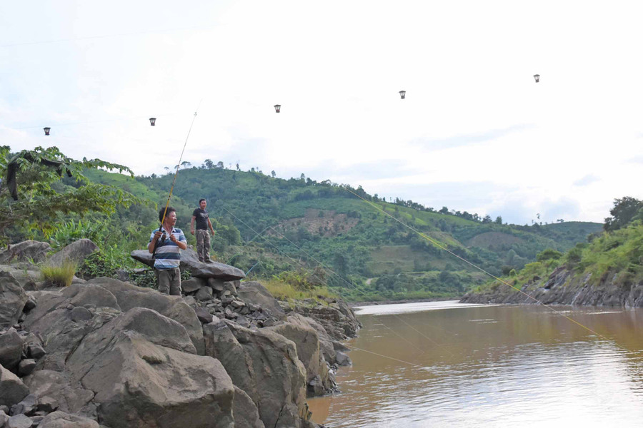 Các “cần thủ” câu cá dưới chân đập thủy điện Sê San 3. Ảnh: Minh Nguyễn