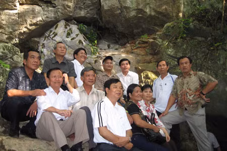 Chụp ảnh lưu niệm trước cửa hang Cốc Bó. 