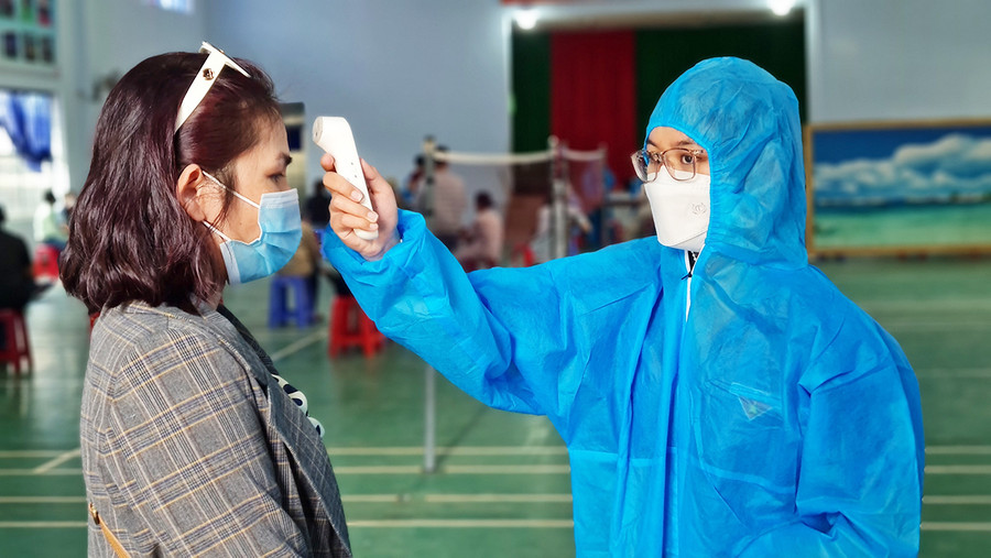 Kiểm tra thân nhiệt người dân trước khi tiêm phòng vắc xin Covid-19 tại điểm tiêm Trường Tiểu học Nguyễn Văn Trỗi (phường Hoa Lư, TP. Pleiku). Ảnh: Bá Bính  Kiểm tra thân nhiệt người dân trước khi tiêm phòng vắc xin Covid-19 tại điểm tiêm trường Nguyễn Văn Trỗi (phường Hoa Lư, TP. Pleiku). Ảnh: Bá Bính