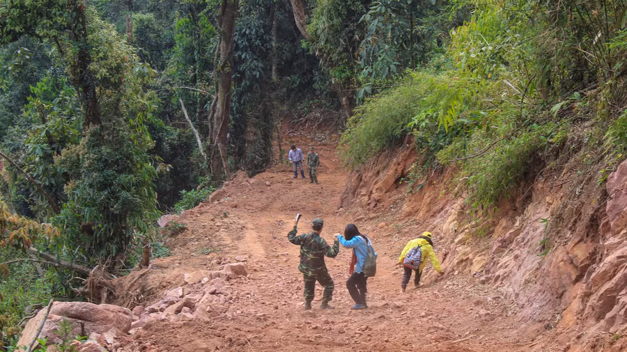 Đường lên cột mốc trơn trượt, dốc đứng đầy khó khăn, các chiến sĩ và du khách phải bỏ xe ở bìa rừng hành quân lên cột mốc