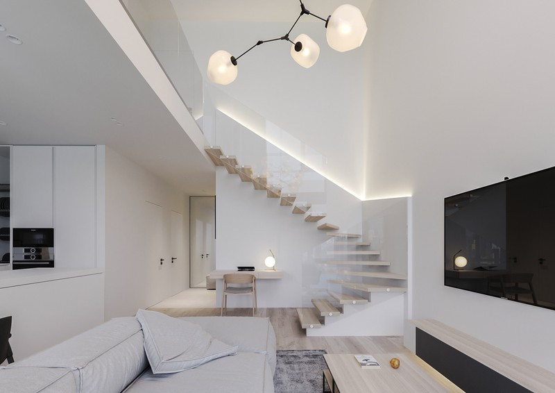  Tay vịn cầu thang làm bằng kính dẫn lên khu gác lửng. Đèn led được bố trí ở cạnh tường làm nổi bật khu vực cầu thang.