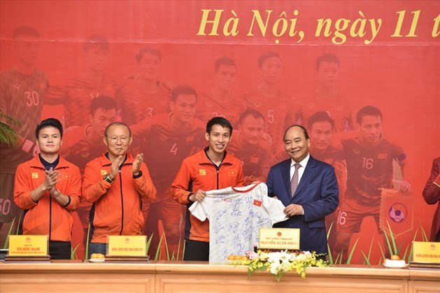 Thủ tướng nhận chiếc áo đấu có chữ ký của các cầu thủ U22 Việt Nam. Ảnh: Đ.H