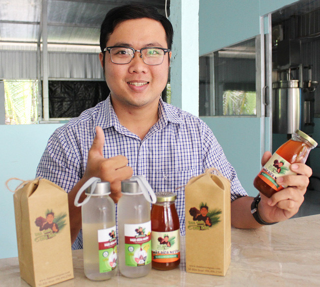 Phan Minh Tiến và hai sản phẩm do anh tạo ra từ mật dừa nước - Ảnh: Q.L. Phan Minh Tiến và hai sản phẩm do anh tạo ra từ mật dừa nước - Ảnh: Q.L.