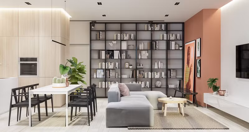 Giá sách đặt cạnh ghế sofa giúp tách biệt phòng khách và phòng ăn mà không cần dùng vách ngăn.