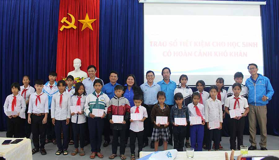  Ban tổ chức chụp hình cùng các học sinh dân tộc thiểu số được nhận sổ tiết kiệm. Ảnh: T.B