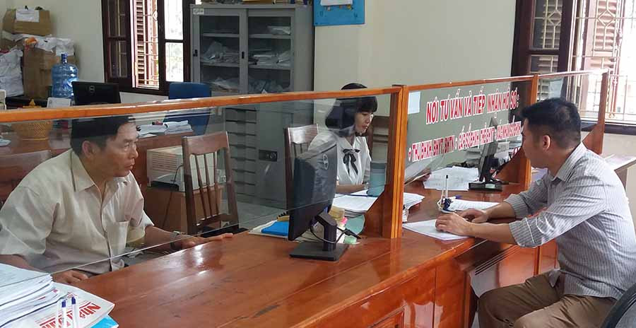  Cán bộ BHXH tỉnh hướng dẫn người dân các thủ tục liên quan đến BHXH, BHYT. Ảnh: N.N