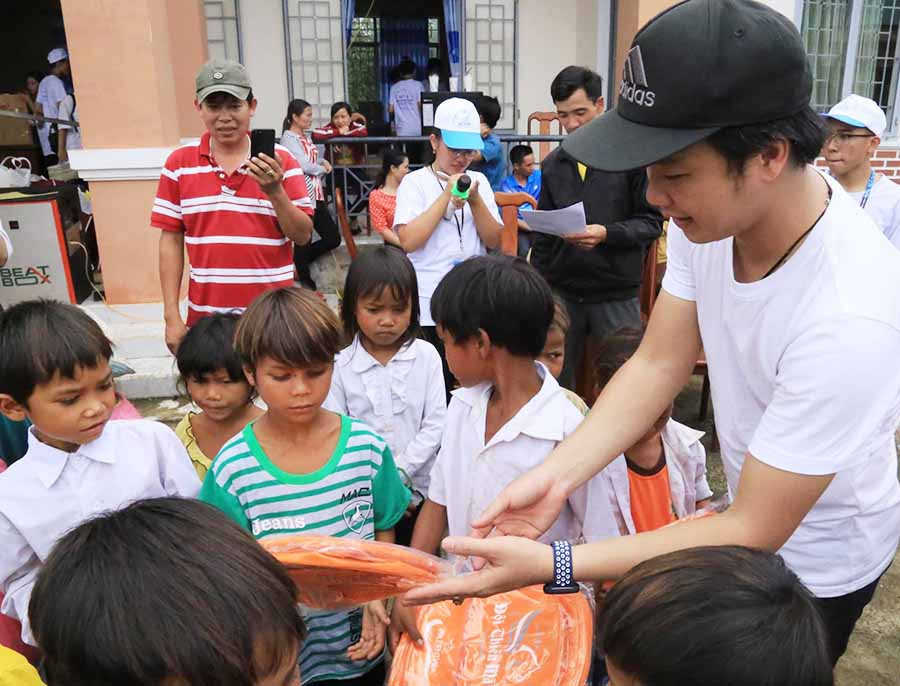 Anh Đoàn tặng quà cho trẻ em nghèo trong chuyến đi từ thiện về huyện Kông Chro. Ảnh: Hồng Thương
