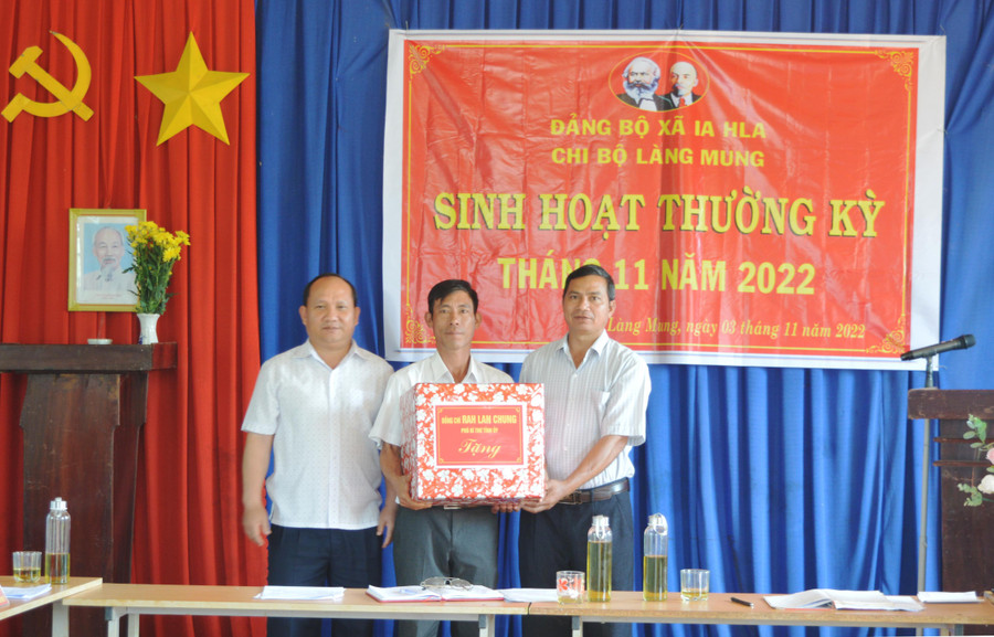 Phó Bí thư Tỉnh ủy Rah Lan Chung (bìa trái) tặng quà cho Chi bộ làng Mung. Ảnh: Phương Dung