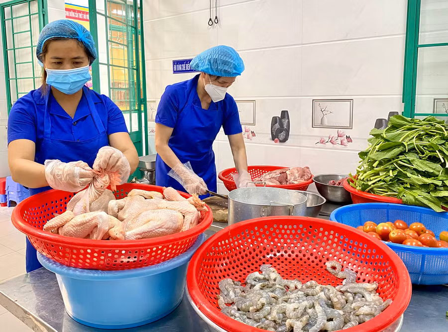 Nhân viên cấp dưỡng Trường Mầm non Hoa Hồng (phường Hội Thương, TP. Pleiku) chế biến thực phẩm chuẩn bị bữa trưa cho trẻ bán trú. Ảnh: Mộc Trà