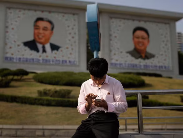 Một người đàn ông đang sử dụng điện thoại thông minh tại thủ đô Bình Nhưỡng, Triều Tiên - Ảnh: AP