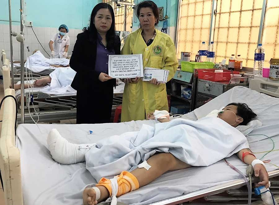  Cô Đồng Thị Thanh Hải (trái)-Hiệu trưởng Trường Tiểu học Võ Thị Sáu trao số tiền nhà trường giúp đỡ cho em Hiếu. Ảnh: Đ.Y