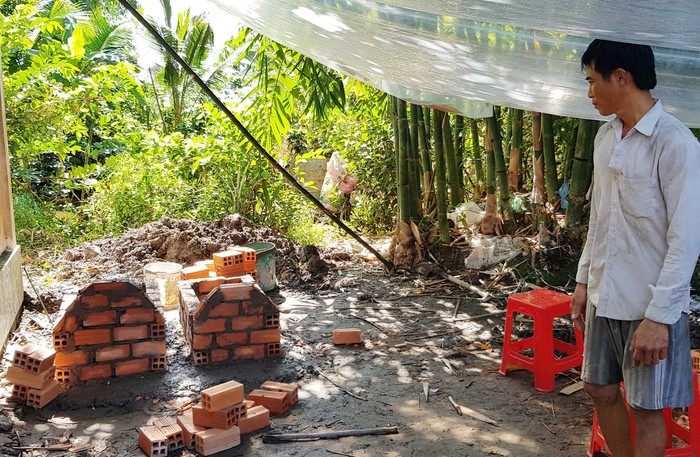 Anh Phạm Thanh Vũ bên phần mộ của hai con. Ảnh: Việt Tường.  Anh Phạm Thanh Vũ bên phần mộ của hai con. Ảnh: Việt Tường.