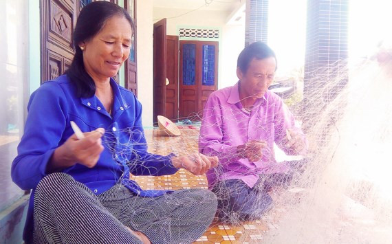 Bà Dạnh và chồng sửa lưới để chuẩn bị ra khơi xa đánh bắt cá.