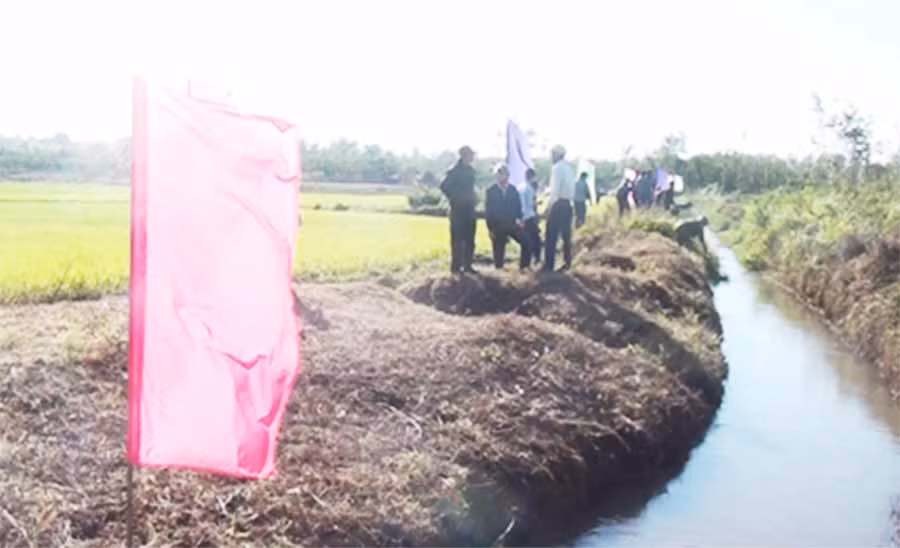  Cán bộ và người dân tham gia phát quang bụi dậm và nạo vét kênh mương đưa nước vào đồng ruộng. Ảnh: HV