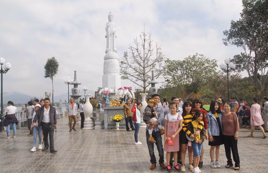 Nhiều người tham quan và chụp hình lưu niệm tại tượng Quan Âm. Ảnh: Văn Ngọc 