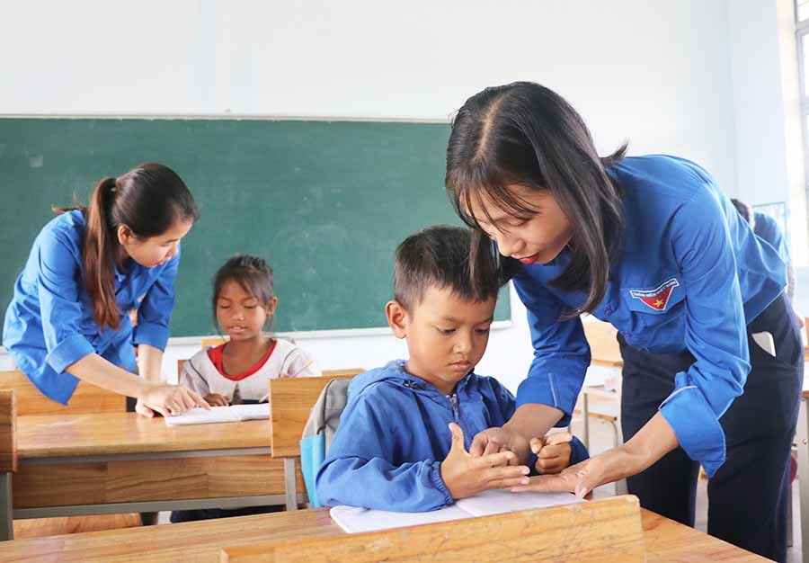 Đoàn viên thanh niên xã Tú An (thị xã An Khê) giúp học sinh ôn bài. Ảnh: N.M Đoàn viên thanh niên xã Tú An (thị xã An Khê) giúp học sinh ôn bài. Ảnh: N.M