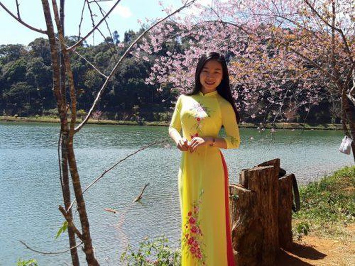 Thiếu nữ chụp ảnh tạo dáng bên những bông hoa Mai anh đào